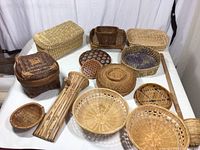 Photo showing all baskets and trays arranged on a white surface, variety of shapes, sizes and colors.