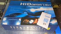 Box of HID Xenon lights with front image showing car lights and HID branding.