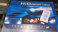 Box of High Intensity Discharge Xenon Light with car headlight images and usage details.