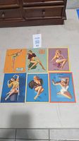 Top-down view of all six pin-up mutoscope cards arranged in two rows, showing colorful vintage illustrations