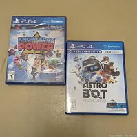 Front cover of Knowledge is Power and Astro Bot Rescue Mission game cases showing titles and artwork for two PS4 games.