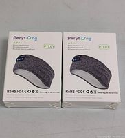Front view of two boxed Perytong PTL01 wireless sleep headphone headbands in gray fabric packaging with product image and certifications.