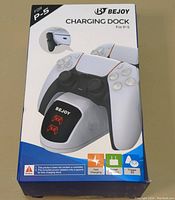 Front view of Bejoy PS5 Charging Dock packaging showing dock and dual controller charging capability with LEDs and icons.