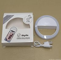 Photo of Diyife branded selfie ring light including USB charging cable and the original box showing product image and USB logo.