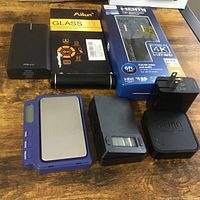 Full view of all items in the lot showing scales, chargers, HDMI cable box, screen protector packages, and wall charger