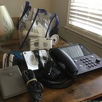 Overall view of the lot showing phone, intercom, sewing pedal, and cables on table.