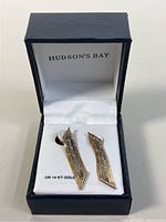 Photo showing the pair of two-toned 14K gold drop earrings inside a blue Hudson's Bay box with white interior.