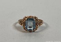 Front view of the antique Victorian 10K gold ring with a blue crystal centerpiece, showing the detailed gold work.