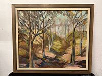 Front view of framed oil painting depicting a forest landscape with trees and a path, showing the entire artwork and frame.