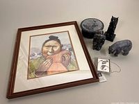 Overview of framed print, trinket box, sculptures and jewelry.