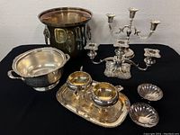 Full overview of all servingware items including candelabra, creamer, sugar bowl on tray, ornate bowl, two small shell dishes, and ice bucket.