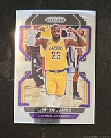 Front side of the 2021-2022 Panini Prizm basketball trading card showing LeBron James in Lakers uniform flexing his arms.