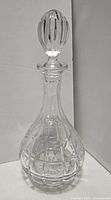 Full view of the crystal decanter with stopper showing the shape and cut design