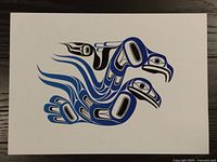 Clear view of the First Nations print with detailed stylized bird artwork in black and shades of blue on white paper.