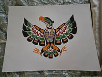 Photo of unsigned print depicting a stylized eagle with outstretched wings in Indigenous art style on white paper.