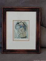 Full view of framed print with wood frame and white mat under glass