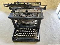 Top and front view of Remington Star No. 6 showing keyboard layout, type-bar basket, and brand name.