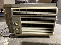 Front view of the Danby window air conditioner highlighting dual control knobs and front ventilation grille.