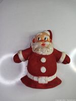 Front view of vintage Santa Claus tree topper showing red and white paint and facial details, with visible dirt and wear