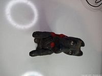 Front view of black Scottish Terrier dog music box with red scarf, showing face and poseable arms.