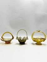 Front view of all three glass baskets showing shape and color variations