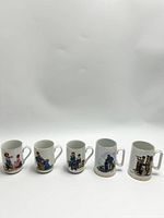 Front view of five vintage ceramic mugs with different Norman Rockwell illustrations on a white background