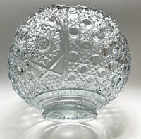 Close-up photo of the bottom and sides of the clear glass punch bowl showing detailed pressed glass pattern and thick base.
