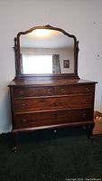 Full view of the dresser with attached mirror, showing overall condition and shape