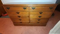 Front view of solid maple dresser with six drawers and antique brass handles