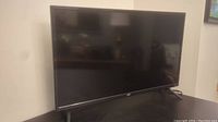 Black 32-inch JVC flat screen TV on stand.