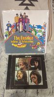 Beatles Yellow Submarine paper pamphlet and Let It Be CD in jewel case with cover art
