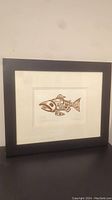 Front view of framed embossed copper-colored Haida salmon print showing entire frame and artwork