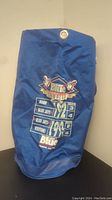 Full side view of blue bat bag showing printed Blue Jays championship details and logos from 1992 and 1993 seasons with game scores and Labatt Blue branding.