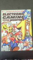 Front cover of Electronic Gaming Monthly issue #100 from November 1997 showing colorful artwork with prominent video game characters like Mario, Sonic, and others.