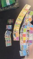 Photo showing spread and stacks of Pokémon cards, both Japanese and English, arranged on a surface.