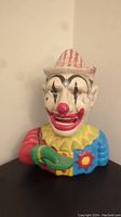 Front view of vintage cast iron mechanical clown coin bank showing detailed paintwork and facial features