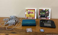 Overall view of lot: two consoles, two boxed games, two loose cartridges, two AC adapters