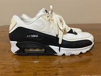 Side view of the Nike Air Max running shoe showing black and white color blocking and visible Air Max bubble in sole