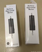 Two unopened boxes labeled 'Battery Operated Motor' showing the image of the motor.