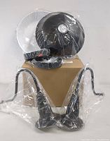 Two black MIINO wall sconces with curved mounting arms, black and white mounting plates, all wrapped in plastic.