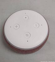 Top view of pink Amazon Echo Dot 3rd Generation speaker showing white top with control buttons for volume, microphone off, and action.