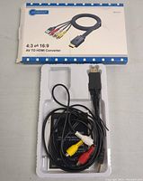 AV to HDMI converter device with three RCA cables (yellow, white, red) and HDMI cable on white plastic tray under packaging box.