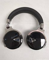 Top view of Cowin wireless headphones showing padded headband and glossy ear cups with Cowin branding.