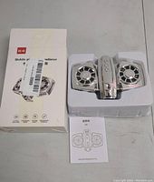 Photo of the full lot including the mobile phone radiator device in white plastic tray, original white box with red 'K4' logo, partial barcode label, and instruction manual.