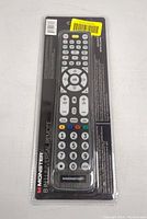 Front view of Monster 8-in-1 universal remote in sealed blister packaging, showing button layout and branding.