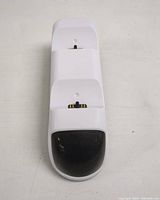 Front view of white dual charging dock with two controller slots and charging connectors.