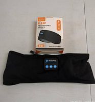 Sleep Headphones Sports box with the black headband featuring Enjoying branded control panel