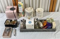 Full view of entire cologne and cosmetic collection, showing boxes, bottles, soaps, and containers arranged on table