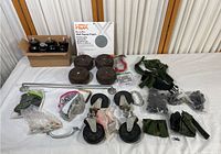 Overview of assorted furniture and hardware items including casters, leveling feet, handles, straps, metal brackets, and a boxed HDX wash repair patch.