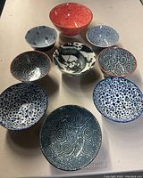 Top view of all 10 soup bowls arranged together showing various patterns and colors.